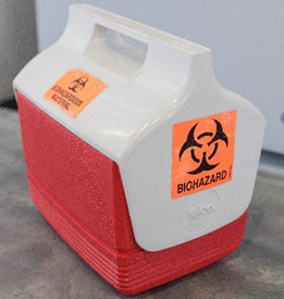 Transport container with a visible biohazard label on it. Transport container with a visible biohazard label on it.