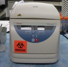 Centrifuge with a visible biohazard label on it.